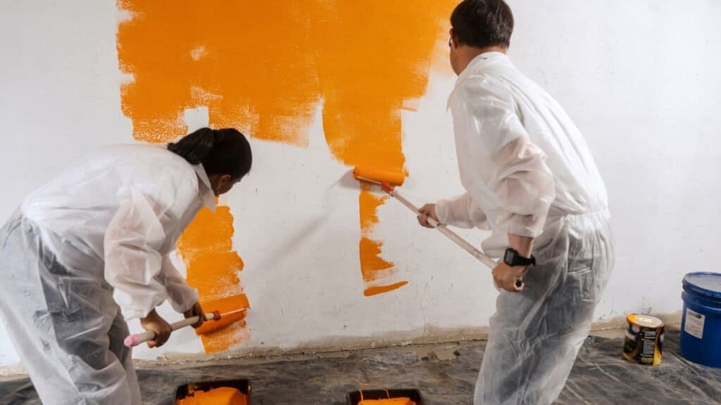 Close-up of painters rolling commercial wall paint